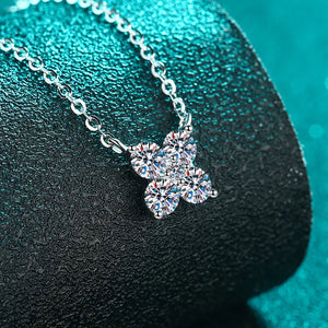 Silver four-stone moissanite clover necklace with delicate chain.