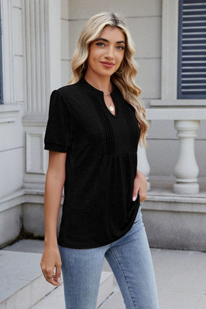 Black short sleeve tee with pleated yoke and keyhole neckline.