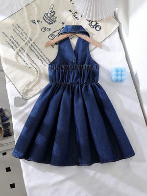 Dark blue denim baby dress with halter neckline, elastic waist, and pleated skirt.