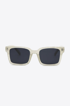 Marble effect rectangular sunglasses with dark lenses and clear frames.