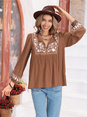 Camel embroidered yoke blouse with gathered bodice and tie neck.