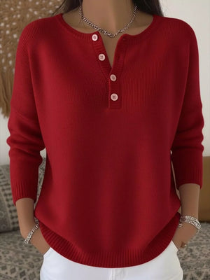 Red buttoned long-sleeve knit top with a henley neckline.