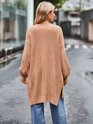 Camel open-stitch waffle knit duster cardigan with side slits and balloon sleeves.