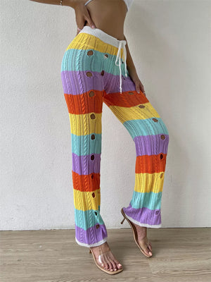 Vibrant crochet knit maternity pants with rainbow stripes and cutout details.