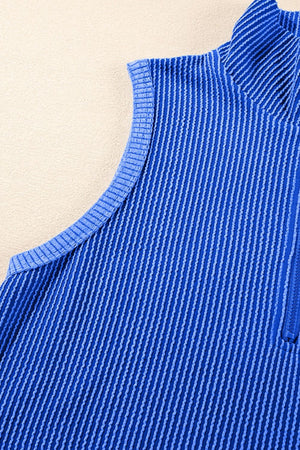Royal blue ribbed knit polo shirt with quarter zip and textured vertical stripes.