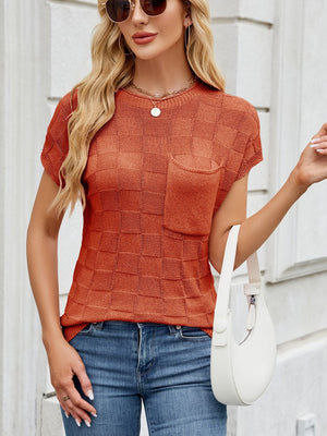 Textured knit t-shirt in rust orange with short sleeves and a chest pocket.