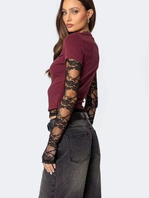 Wine red cropped t-shirt with black lace long sleeves and a crew neck.