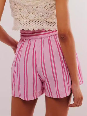 Pink striped shorts with elastic waistband and crochet top styling.
