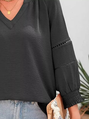 Gray green long sleeve blouse with smocked cuffs and lace trim detail
