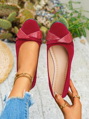 Red slip-on wedge shoes with rhinestone embellished crisscross detail.