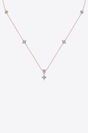 Rose gold necklace with scattered diamond clusters and a central diamond pendant.