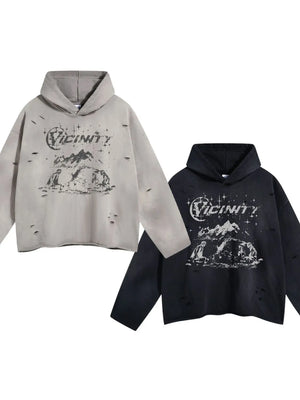 Distressed graphic oversized hoodies in black and gray with a mountain scene print.