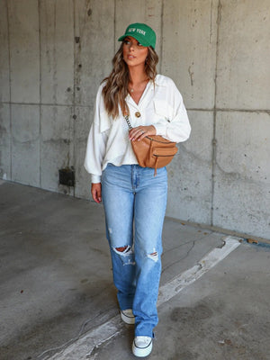 White textured boxy utility shirt jacket with button details and a collared neckline.