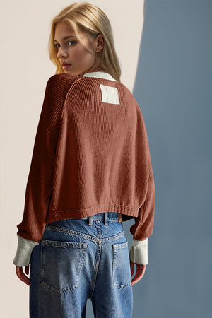 Caramel ribbed raglan sleeve cardigan with contrast trim and square patch detail on back.