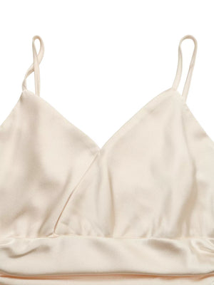 Cream V-neck ruched bodysuit with spaghetti straps and a satin finish.