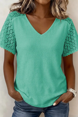 Teal waffle knit V-neck shirt with short lace sleeves and scalloped trim.
