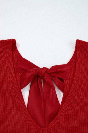 Red knit sweater with backless detail and satin bow tie closure