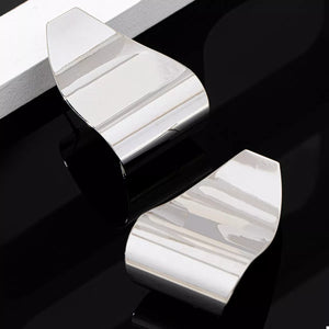 Silver alloy geometric earrings with a polished finish.
