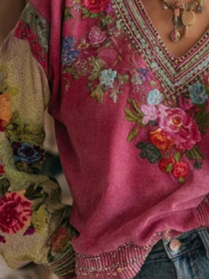 Embroidered deep rose V-neck blouse with floral detail and contrast printed sleeves.
