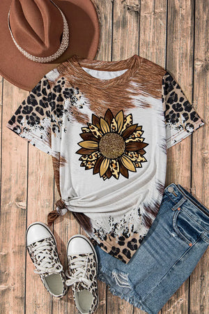 Cowhide sunflower graphic t-shirt with leopard print sleeves and hem.