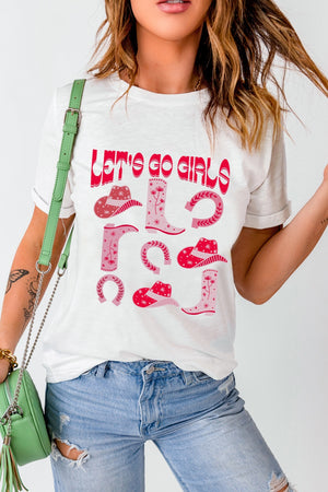 White graphic t-shirt with pink western boots, hats, and horseshoes and "Let's Go Girls" text.