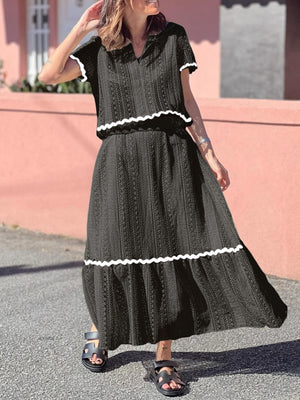 Black crochet co-ord set with scalloped trim and short sleeves, midi skirt.