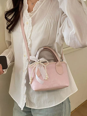 Pearl Bow Charm Crossbody Bag in Blush Pink, front view