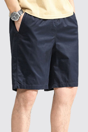 Dark blue casual chino shorts with pockets, above the knee length.