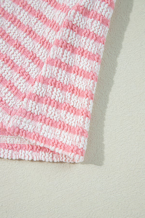 Textured stripe puff sleeve top in blush pink with smocked fabric detail.