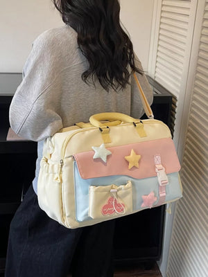Chic color block travel bag with star embellishments and yellow handle.