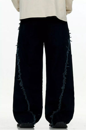 Black wide-leg sweatpants with distressed fringe detail on the sides.