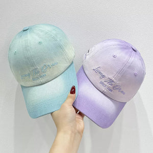 Gradient embroidered cotton baseball caps in light purple and cyan with embroidered text