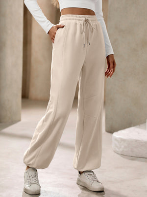 Tan balloon-leg sweatpants with drawstring waist and pockets