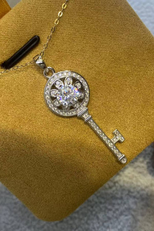 Silver key pendant necklace with floral design and clear crystals