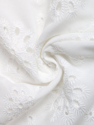 White eyelet embroidered button-up shirt with floral cutouts and breezy fabric.