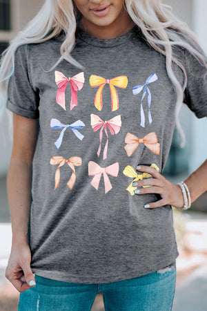 Dark gray t-shirt with a watercolor bow print featuring pink, yellow, blue, and orange bows.