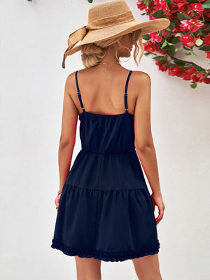 Dark blue camisole tiered mini dress with ruffled hem and spaghetti straps.