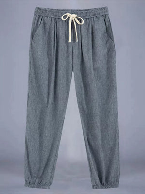 Men's grey relaxed fit drawstring sweatpants with ankle cuffs and pockets.