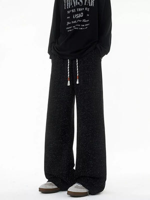 Black textured knit sweatpants with drawstring waist and wide leg