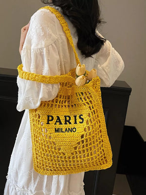 Yellow crochet tote bag with "PARIS MILANO" text detail and flowers.