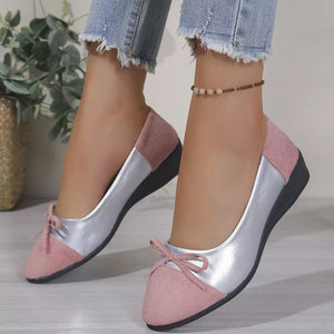 Pink and silver slip-on flats with bow detail.