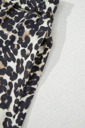 Relaxed leopard print lounge pants with elastic waistband and side pocket detail.