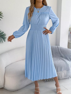 Light blue ruffled smocked waist midi dress with long sleeves and pleated skirt.