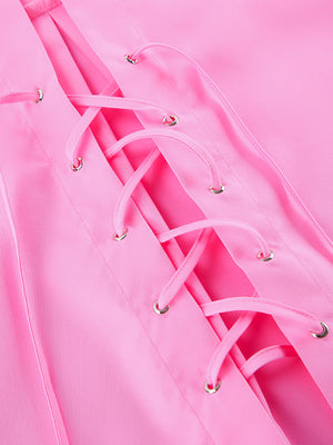 Pink cotton lace-up front shirt with relaxed fit and gold grommets.