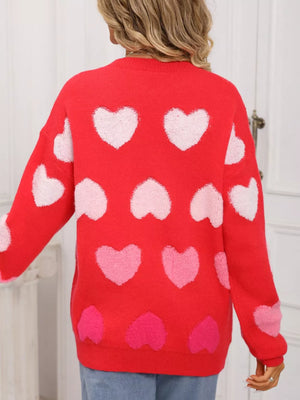 Red fuzzy knit sweater with allover pink and white heart pattern.