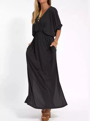 Black V-neck maxi dress with dolman sleeves, elastic waist, side pockets, and side slits.