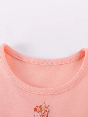 Peach cotton baby dress with fairy embroidery detail and rounded neckline.