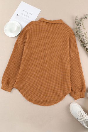 Caramel waffle knit button-down shirt jacket with collared neckline and long sleeves.