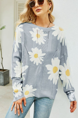 Light gray intarsia knit sweater with allover white daisy pattern and cable knit details.