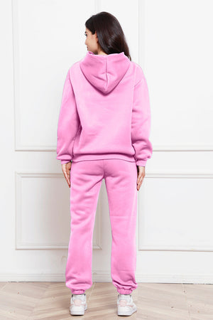Pink relaxed fit hoodie and joggers set with cuffed ankles.